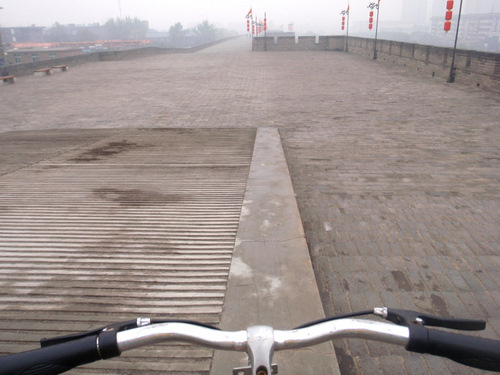 A bike rider chooses to not go down the stairs.